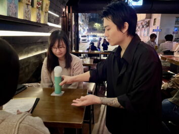 Kaki introducing his drink to customers