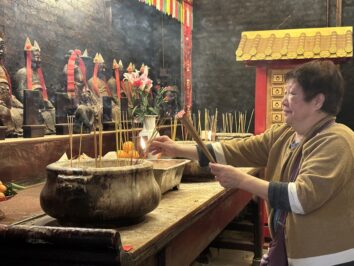 A woman is offering incense