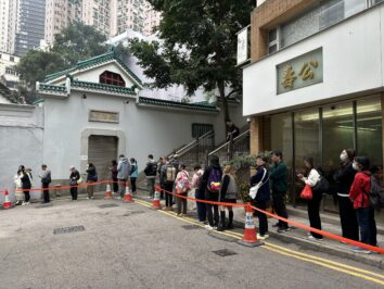 wide shot of people queuing